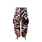 Flat lay of BAM-BAM Pink and Black Bagus Pants showing abstract cubist prints and sustainable streetwear design.