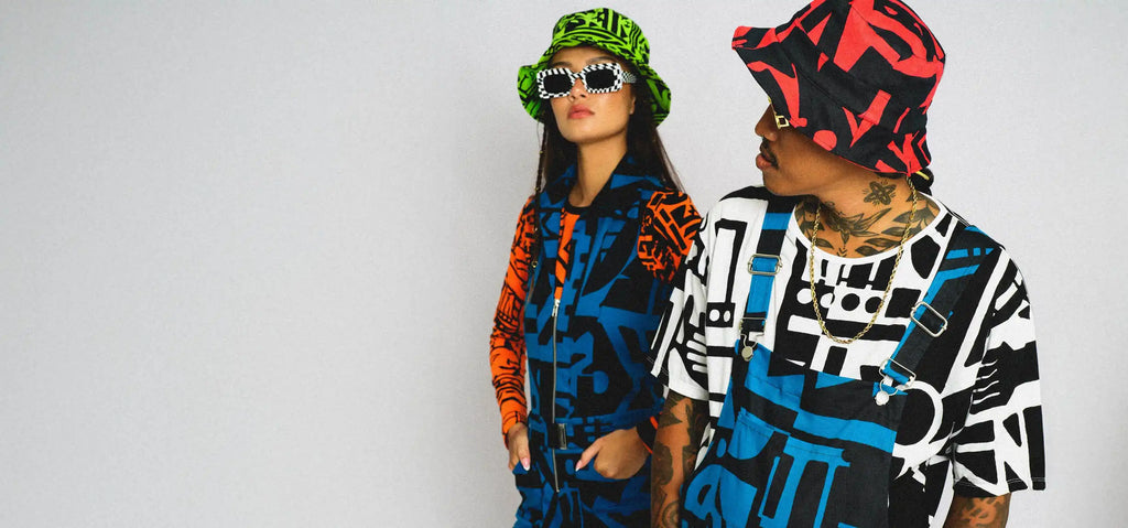 People dressed in Bam-Bam apparel, hats, jumpsuit, t-shirt are colorful and designed with cubist abstract patterns.