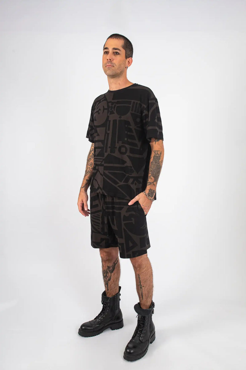 Model pairing Charcoal and Black BAM-BAM Oversized Tee with statement pants, showcasing creative streetwear look.