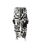 Flat lay of black and white BAM‑BAM bagus pants with abstract prints and sustainable streetwear style