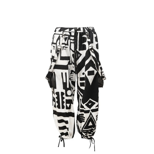 Flat lay of black and white BAM‑BAM bagus pants with abstract prints and sustainable streetwear style