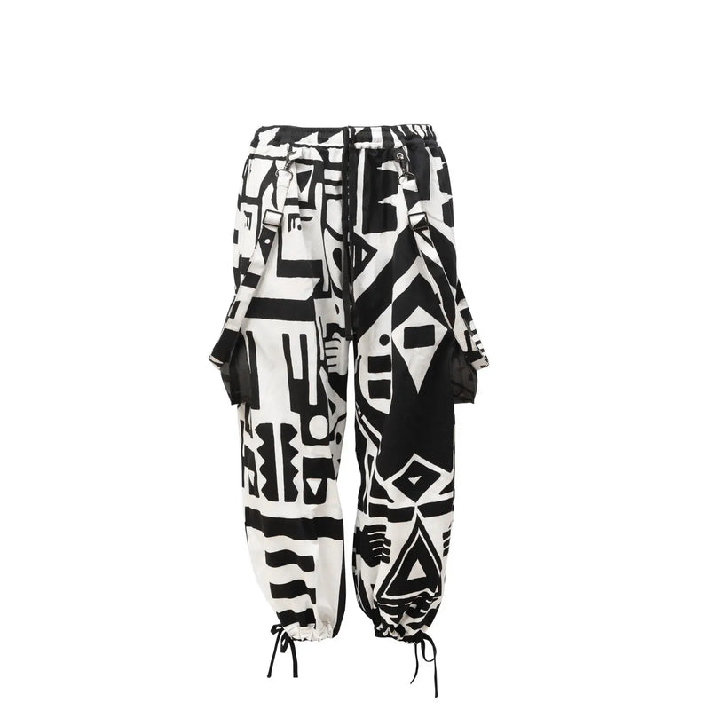 Flat lay of black and white BAM‑BAM bagus pants with abstract prints and sustainable streetwear style