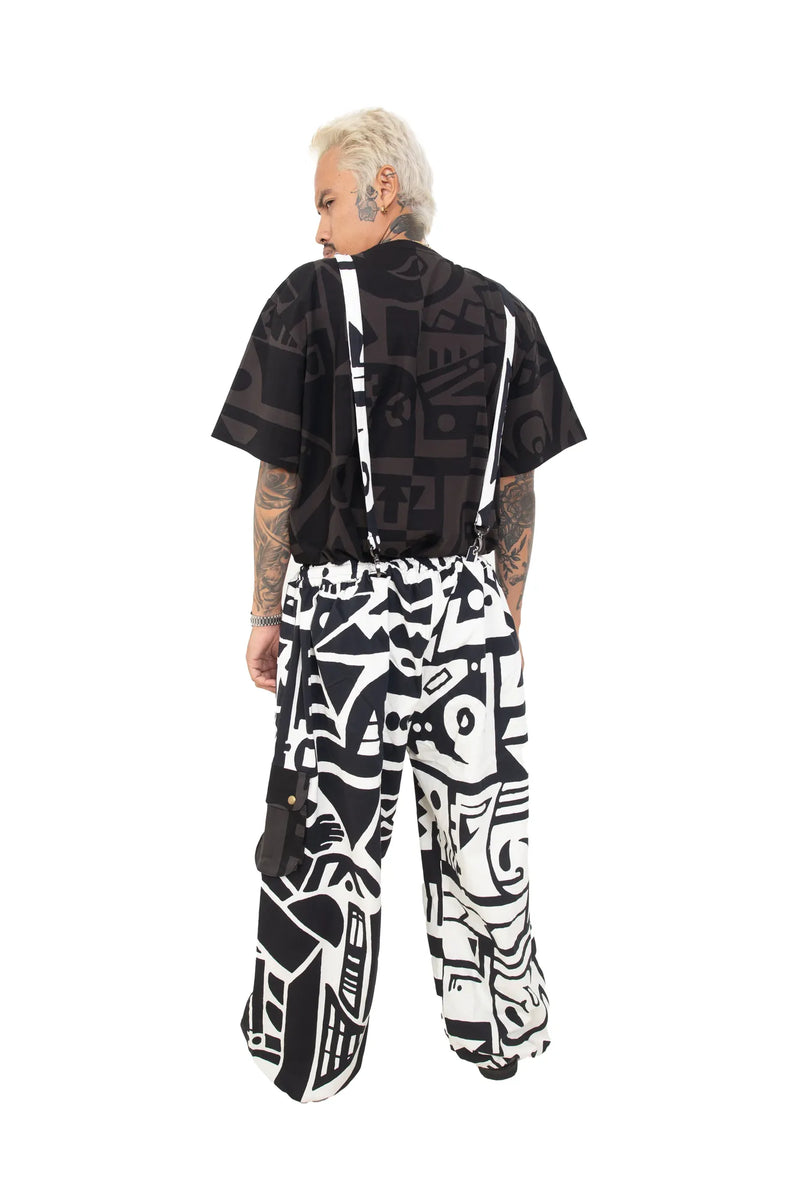 Back view of BAM-BAM black and white graphic overalls with adjustable straps and cargo pockets.