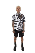 Model standing in black and white BAM‑BAM mesh shirt with layered look expressing self‑expression