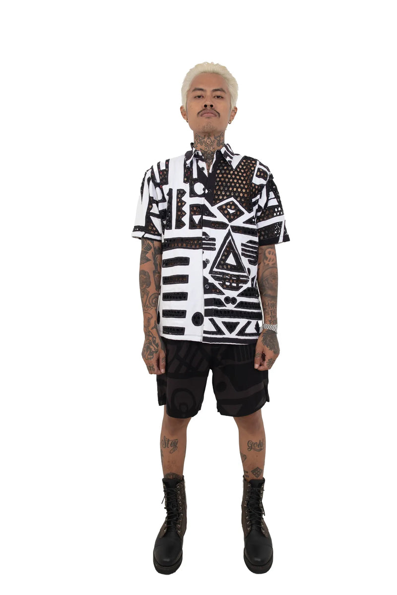 Model standing in black and white BAM‑BAM mesh shirt with layered look expressing self‑expression
