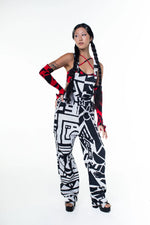 Female model posing in BAM‑BAM black and white dungarees and bra top, embracing wearable art