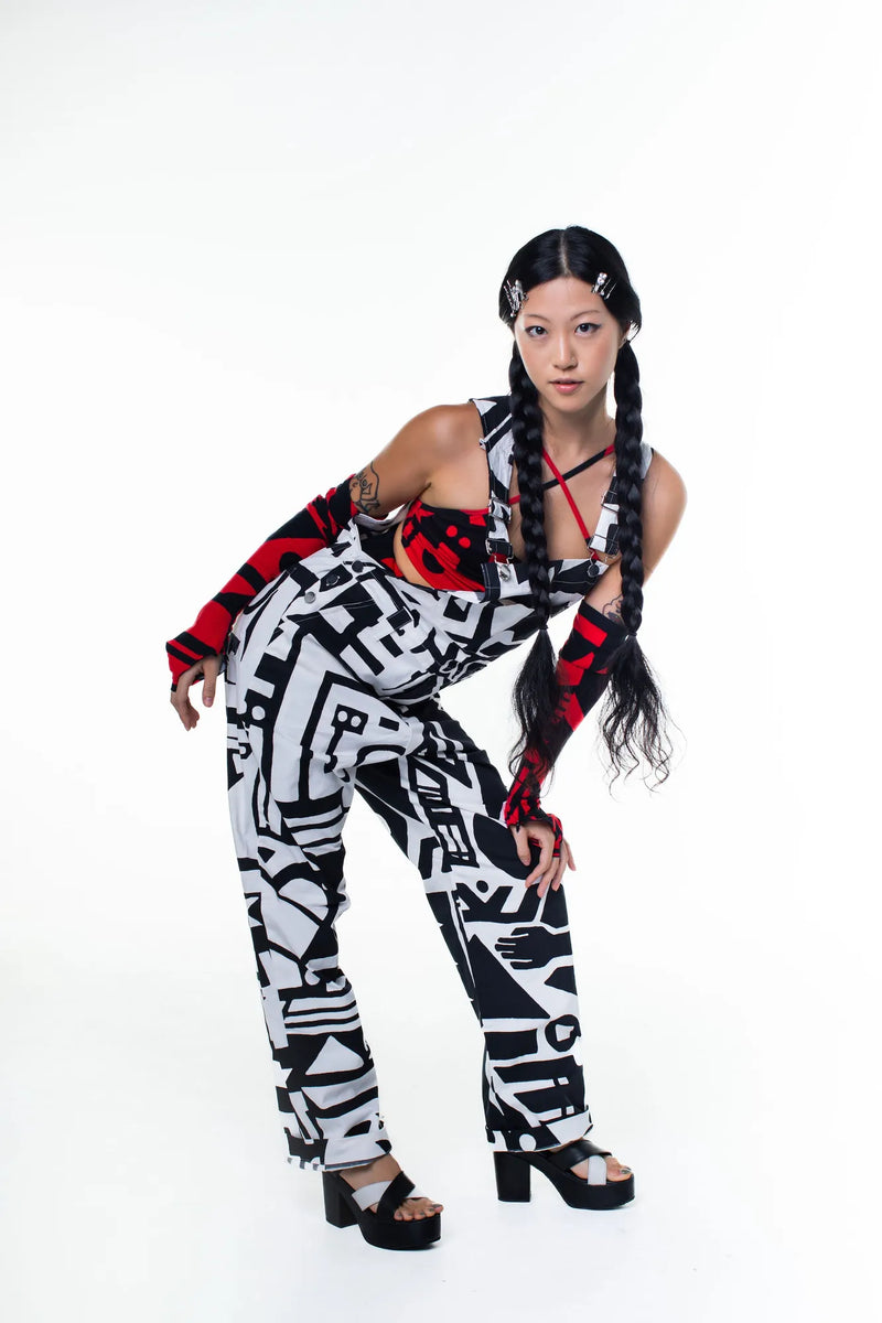 Model standing wearing black and white BAM‑BAM dungarees with abstract prints