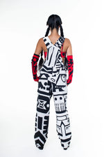 Model wearing black and white BAM‑BAM dungarees and bra tops showcasing wearable art