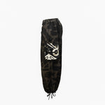 Side view of BAM‑BAM charcoal baggy pants highlighting loose fit and abstract prints