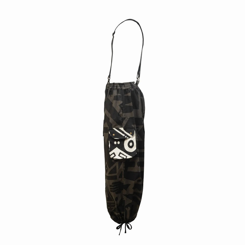 Side view of BAM‑BAM charcoal baggy pants highlighting loose fit and abstract prints