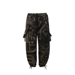 Flat lay of charcoal BAM‑BAM baggy pants with abstract prints and sustainable streetwear style