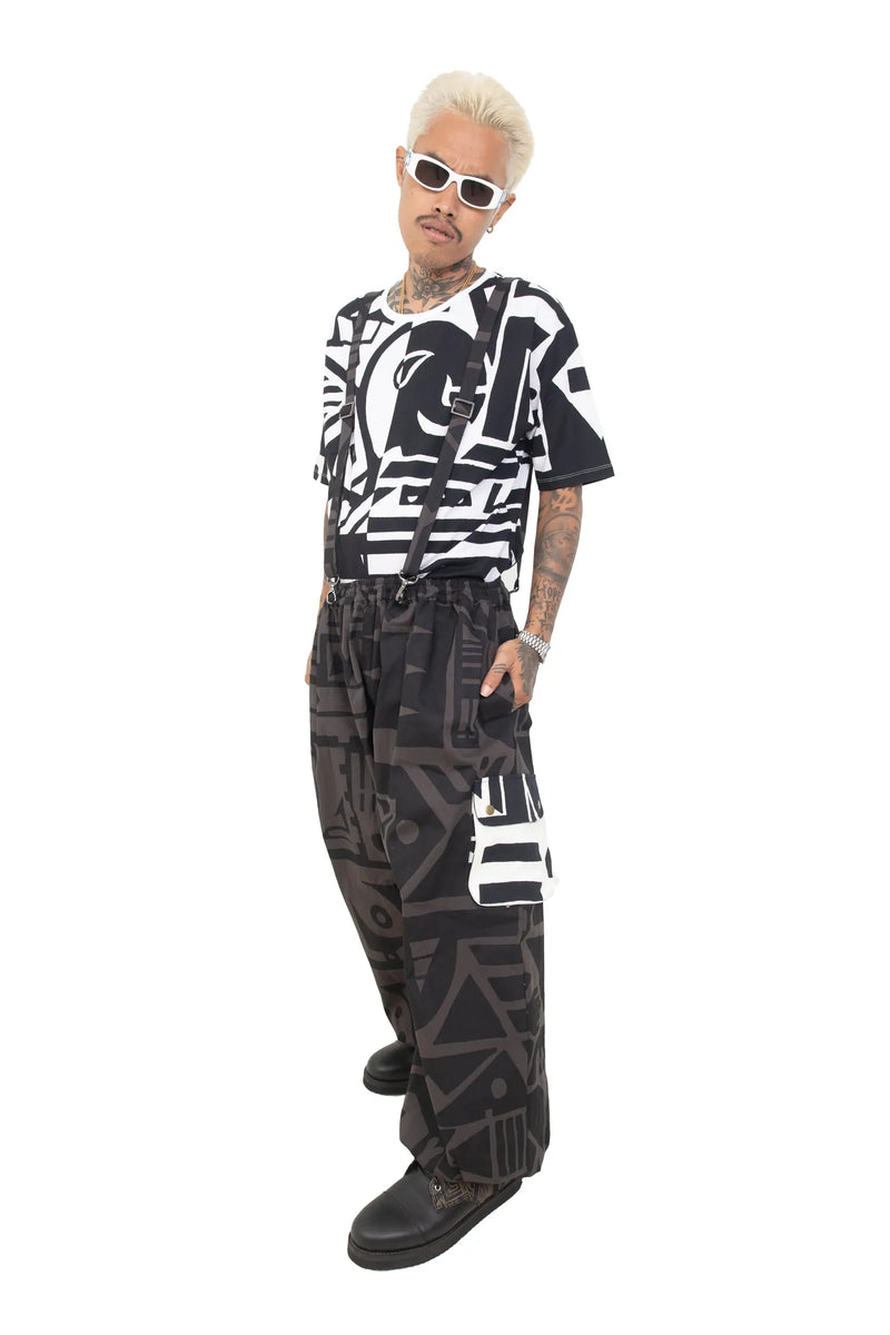 Side view of BAM‑BAM charcoal baggy pants highlighting loose fit and abstract prints
