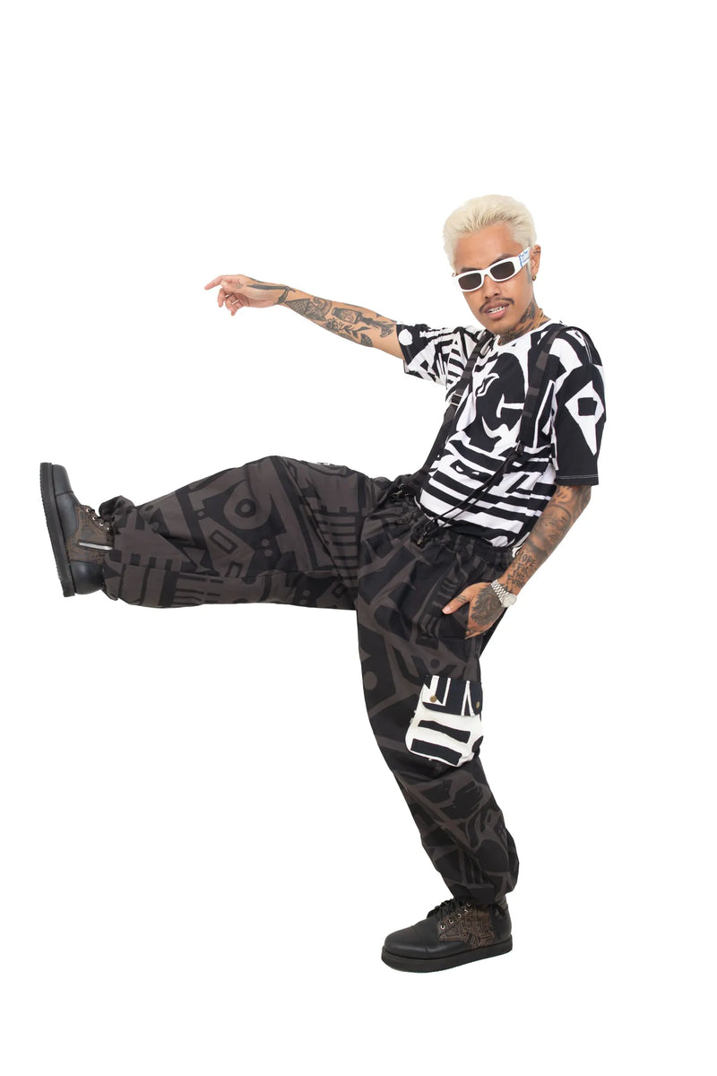 Model dancing in charcoal BAM‑BAM baggy pants showing cubist patternism and abstract prints