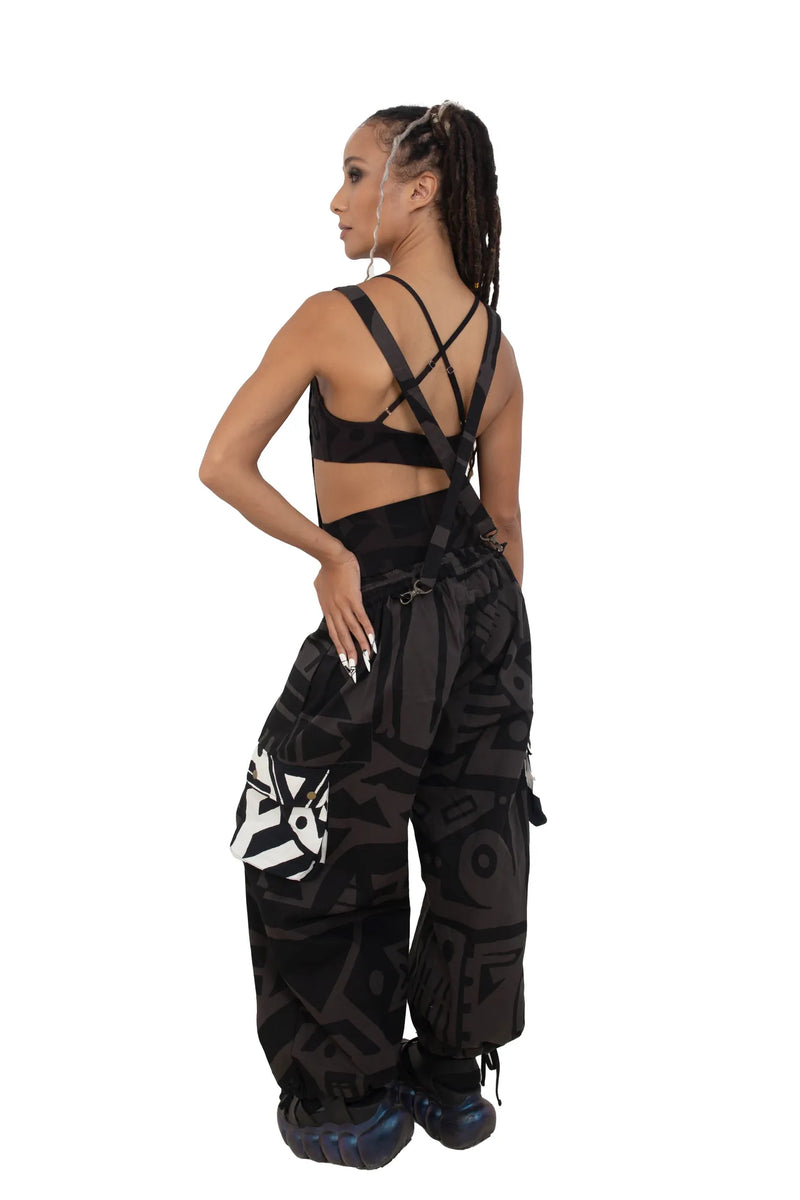 Model standing with hands on hips in charcoal BAM‑BAM baggy pants capturing wearable art