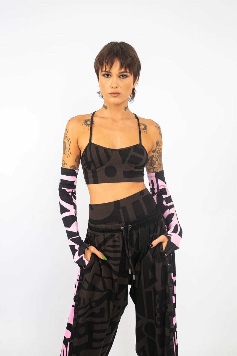 Model showing charcoal black BAM‑BAM bra top highlighting abstract prints and cubist patternism