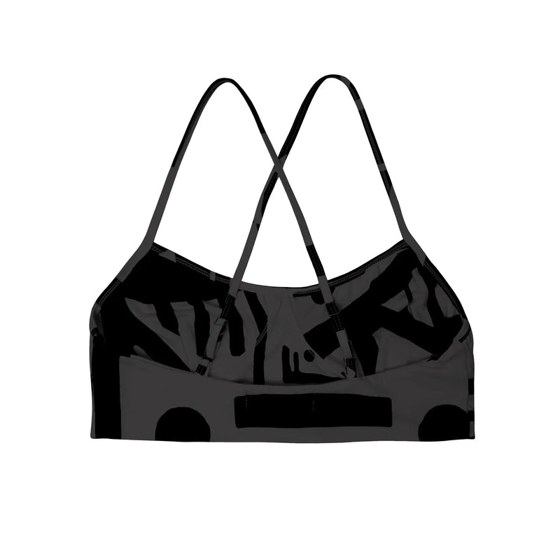 Back view of charcoal black BAM‑BAM bra top reflecting abstract prints and self‑expression