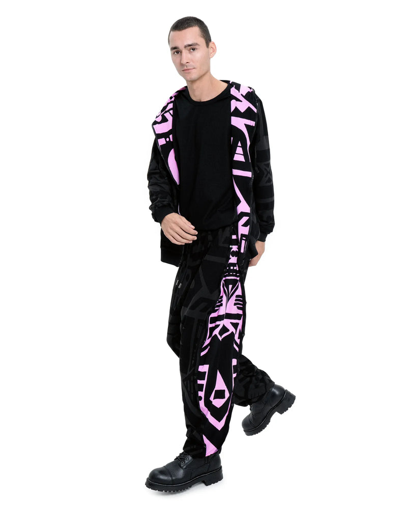 Model dancing in charcoal and pink poppa pants by BAM‑BAM showcasing sustainable streetwear and abstract prints