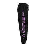 Model flipping hair in charcoal and pink BAM‑BAM poppa pants capturing bold self‑expression