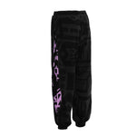 Close‑up of pocket and logo on BAM‑BAM charcoal and pink poppa pants with abstract prints