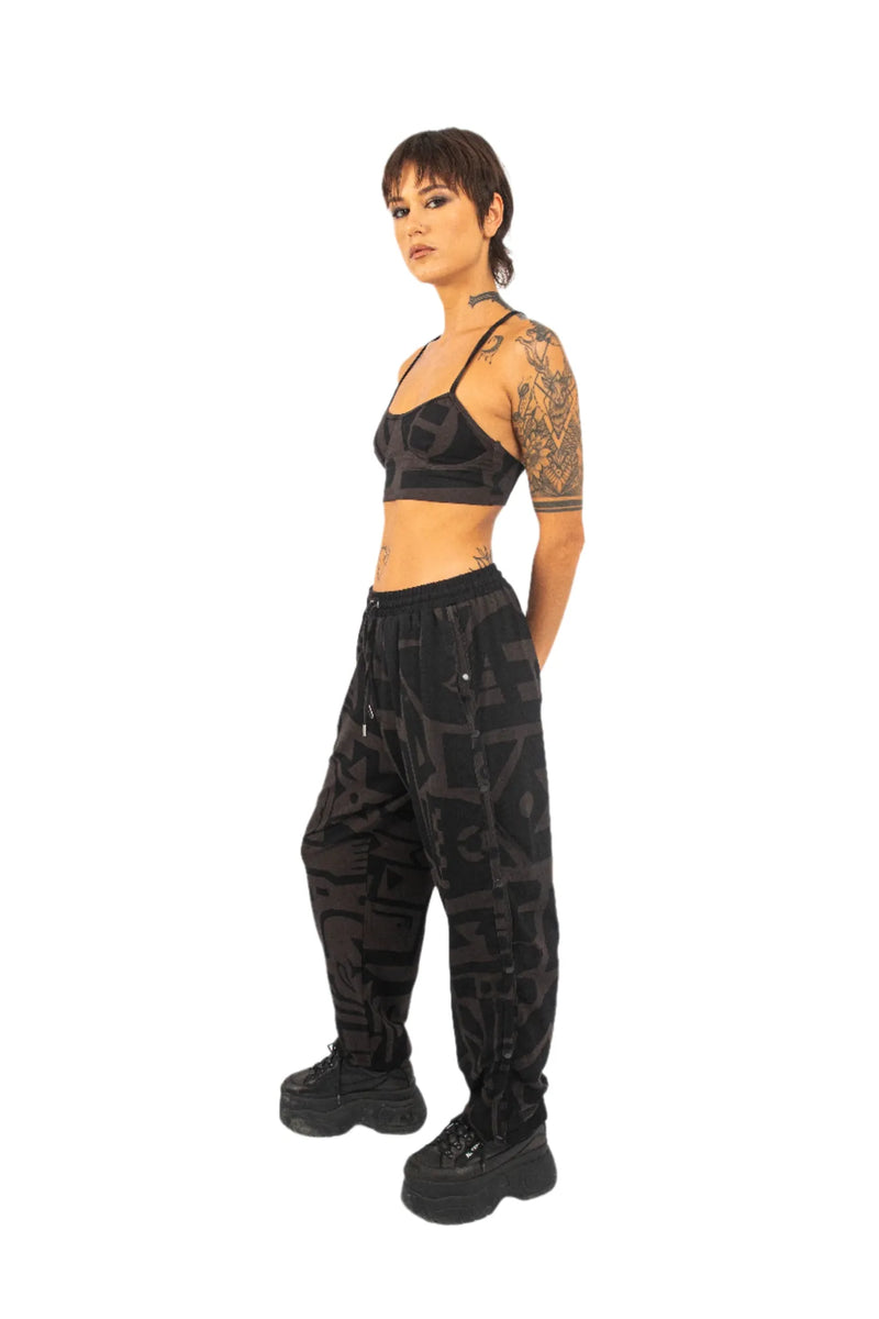 Side view of model in charcoal and pink poppa pants by BAM‑BAM highlighting cubist patternism
