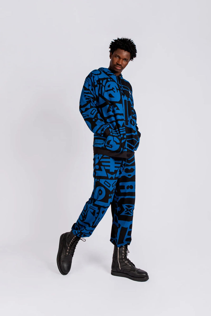 Side profile of male model wearing dark blue and black BAM‑BAM trousers, highlighting sustainable streetwear
