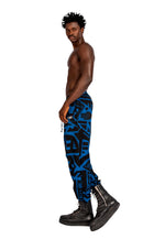 Model wearing dark blue and black BAM‑BAM trousers with abstract prints and cubist patternism