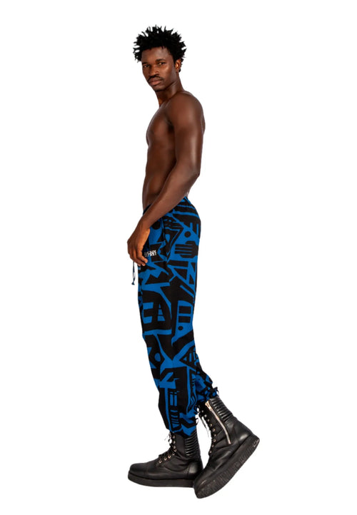 Model wearing dark blue and black BAM‑BAM trousers with abstract prints and cubist patternism