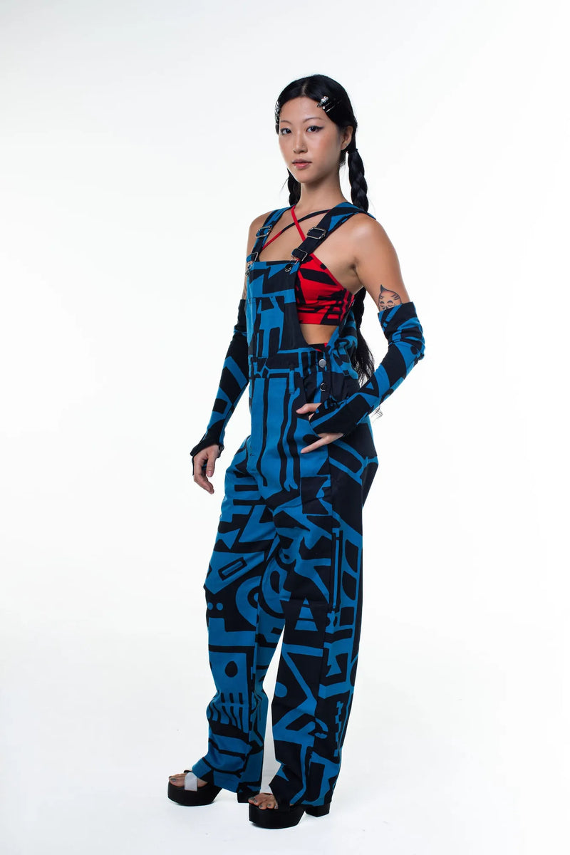 Model on steps in dark blue and black BAM‑BAM dungarees capturing sustainable streetwear and self‑expression