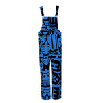 Flat lay of dark blue and black BAM‑BAM dungarees with abstract prints, wearable art and sustainable streetwear