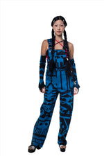 Female model wearing dark blue BAM‑BAM dungarees with abstract prints and cubist patternism