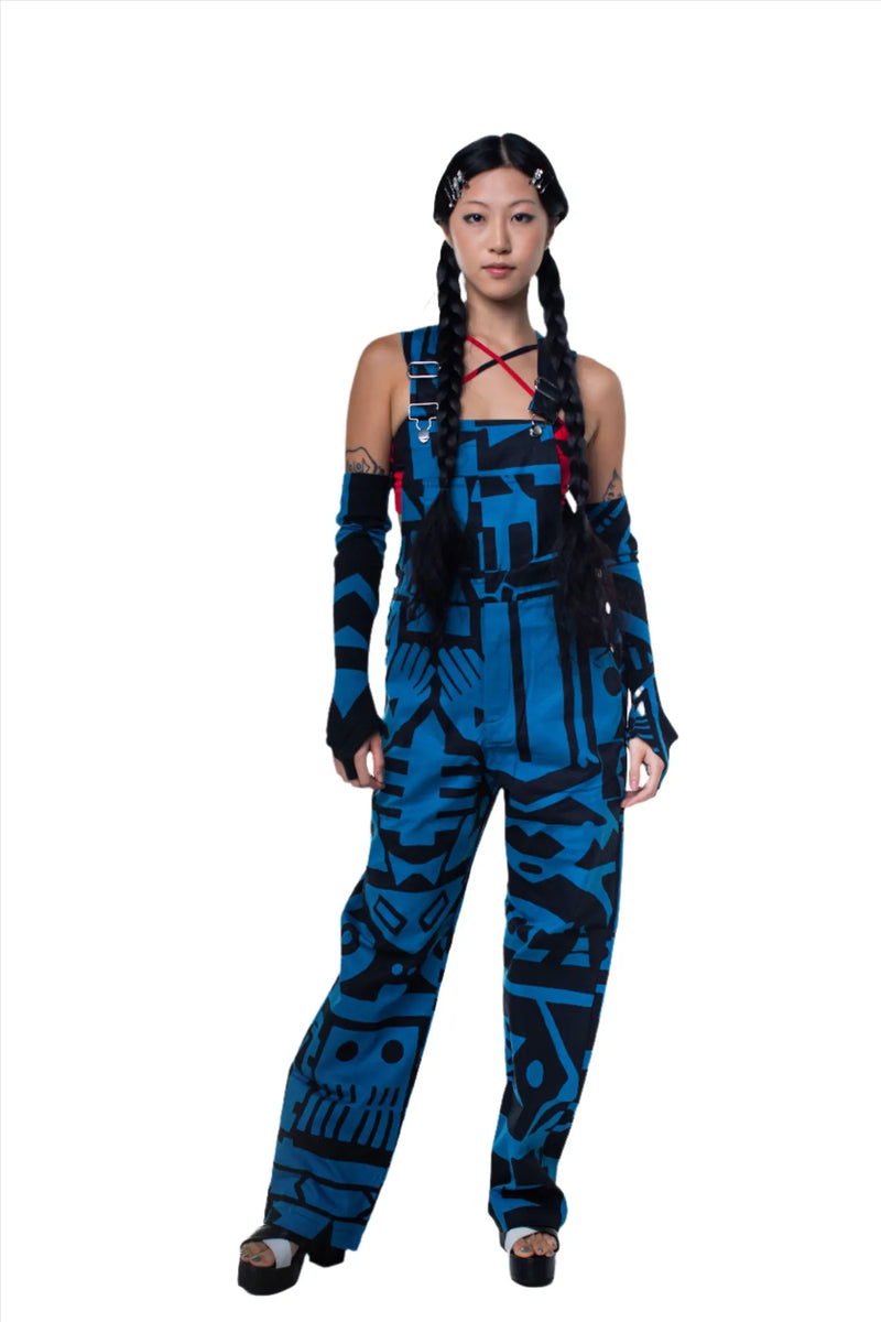 Female model wearing dark blue BAM‑BAM dungarees with abstract prints and cubist patternism