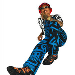 Male model wearing bucket hat and dark blue BAM‑BAM dungarees expressing self‑expression and artistic streetwear