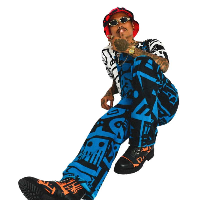 Male model wearing bucket hat and dark blue BAM‑BAM dungarees expressing self‑expression and artistic streetwear