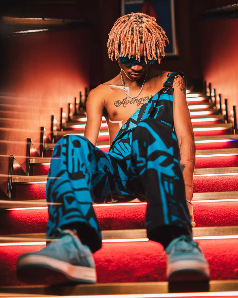 Back view of dark blue BAM‑BAM dungarees highlighting straps and sustainable streetwear craftsmanship
