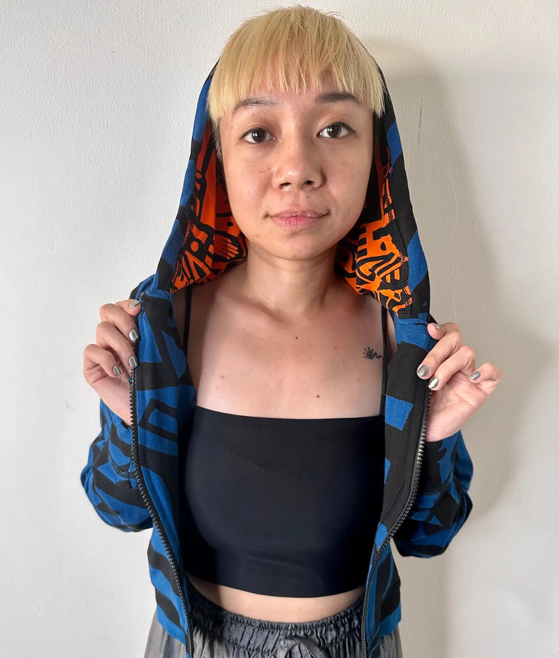 Model wearing dark blue BAM‑BAM mini hoodie with cubist pattern