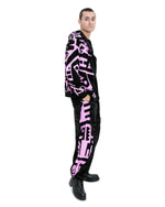 Side view of male model wearing pink side of reversible BAM‑BAM hoodie highlighting cubist patternism