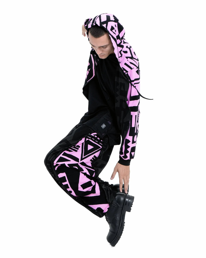 Male model wearing BAM‑BAM reversible hoodie half zipped revealing pink lining and artistic streetwear