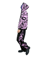 Male model wearing pink side of BAM‑BAM reversible hoodie with graphic print capturing wearable art