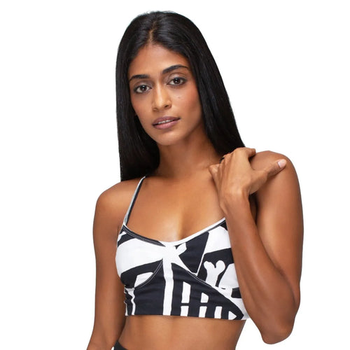 Model wearing black and white BAM‑BAM bra top and matching shorts showing abstract prints and cubist patternism