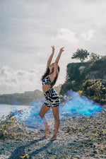 Model in bamboo bra top with smoke effect behind, featuring abstract prints and cubist patternism by BAM‑BAM