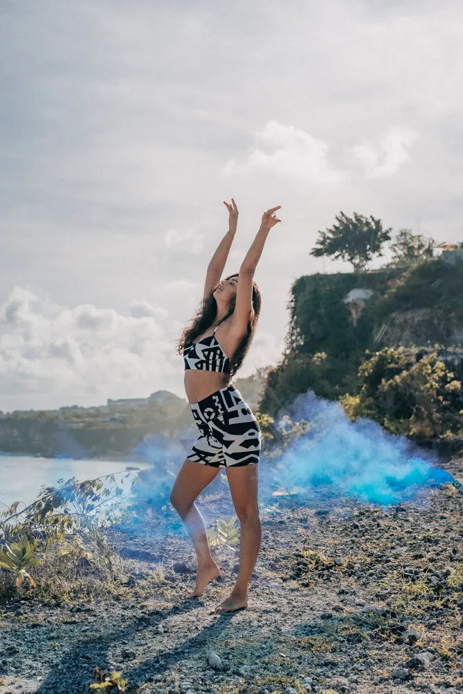 Model in bamboo bra top with smoke effect behind, featuring abstract prints and cubist patternism by BAM‑BAM